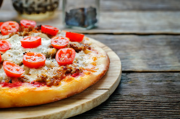pizza with meat, mozzarella and tomatoes