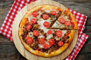 pizza with meat, mozzarella and tomatoes