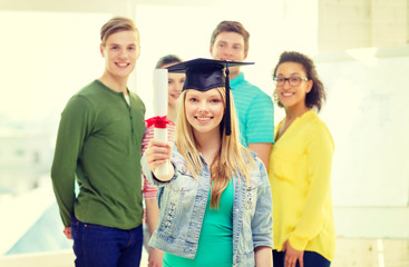 smiling female student with diploma and corner-cap