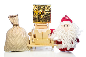 Santa Claus with wooden car, gift box and sack