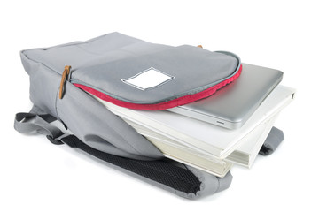 Backpack full of school supplies. on white background.