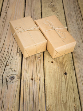 two brown paper and string parcels