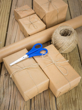 brown paper parcels with paper string and scissors