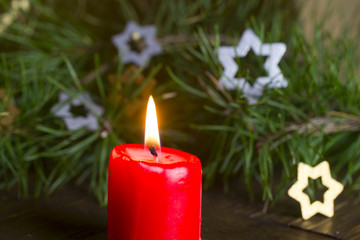 Red candle by the Christmas tree