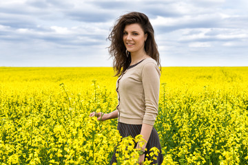 Naklejka na ściany i meble woman portrait in yellow flower field