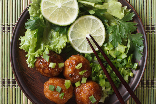 fish balls in curry sauce with lime top view