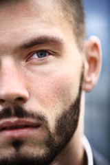 Charming and handsome man half face close up