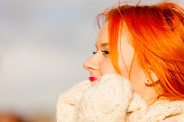 Beauty face redhaired woman in warm clothing outdoor