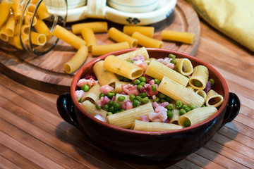 italian pasta called macaroni with ham and peas