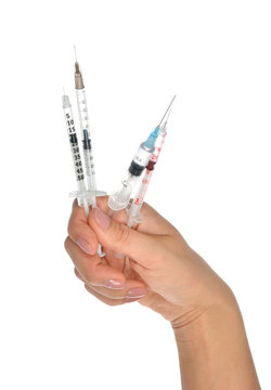 Doctor hand with medical insulin syringes ready for injection