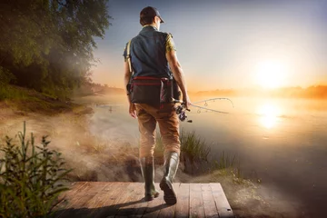 Zelfklevend Fotobehang Young man fishing at misty sunrise © vitaliy_melnik