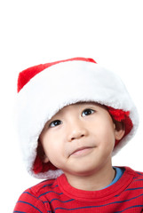Cute Vietnamese boy wearing Christmas hat on white background