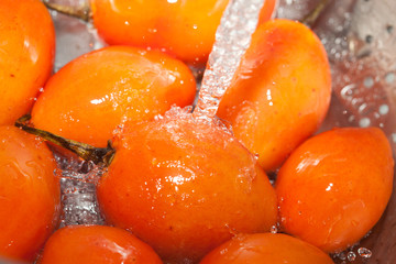 washing produce under strong jet of water