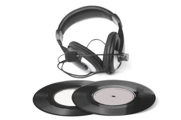 headphones arranged over some old 45 rpm - Stock Image