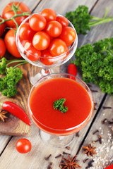 Tomato juice in goblet and fresh vegetables