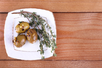 Green olives in oil with spices and rosemary