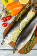 Fresh raw fish and food ingredients on table