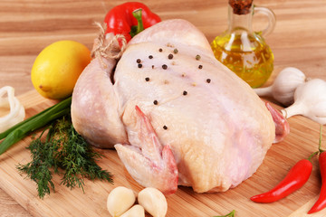Raw chicken on wooden table