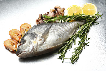 Fresh fish and other seafood with lemon close-up