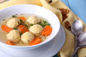 Soup with meatballs and noodles in bowls