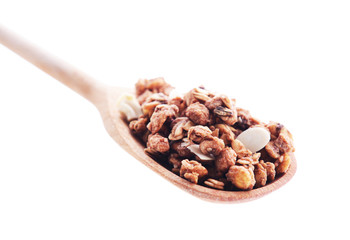 Granola in spoon isolated on white