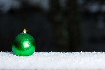 Green Christmas ornament on railing