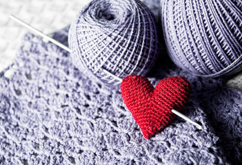 Threads with red handmade knitted  heart