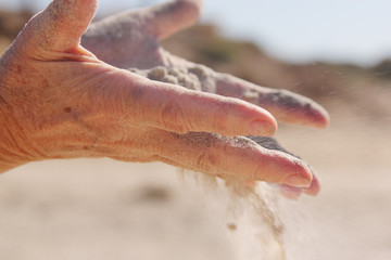 woman with sand in hands