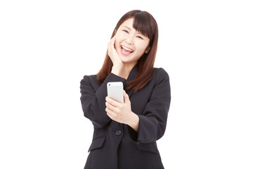 Fototapeta premium スマートフォンを持って喜ぶビジネスウーマン