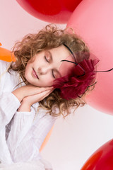 Beautiful girl with a bow on her head with eyes closed
