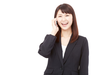Fototapeta premium スマートフォンで通話して笑うビジネスウーマン