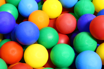 colored balls with very vivid colors into a pool of balls