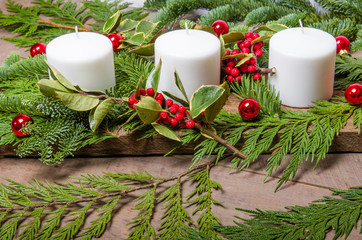 Evergreen Christmas centerpiece with white candles