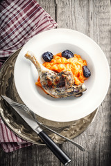 Roasted duck leg with mashed carrot and dried prunes