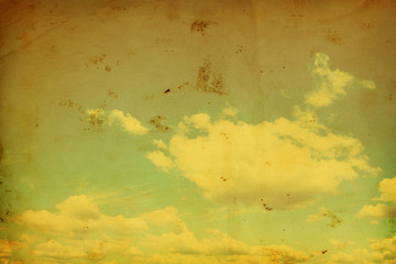 Blue sky with clouds in grunge and retro style.