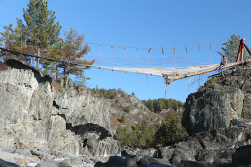 The destroyed bridge among mountains