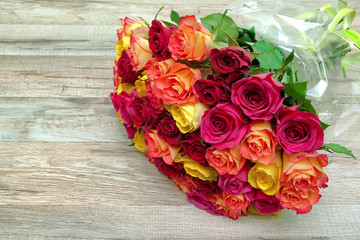 a bouquet of roses on a wooden background close up