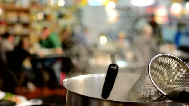 Chef pours water into the pot