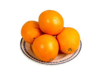several oranges in an old dish