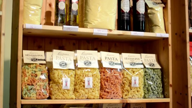 colourful pasta (olive oil, flour etc.) in bags in shelf - shop