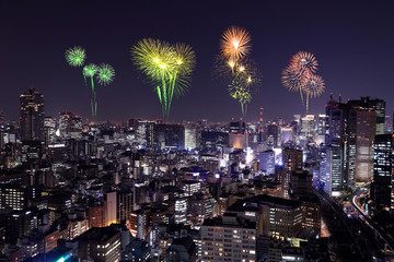 Fireworks celebrating over Tokyo cityscape at night