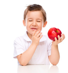 Portrait of a happy little boy with apples