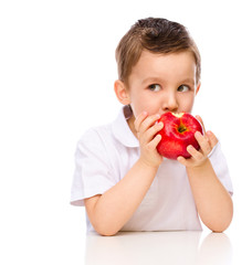 Cute boy with red apples