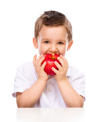 Cute boy with red apples