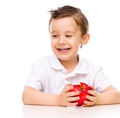 Cute boy with red apples
