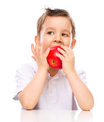 Cute boy with red apples