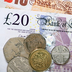 British currency bank notes and coins in close up