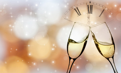 Glasses with champagne and clock close to midnight