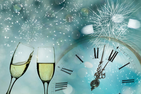 Glasses with champagne and clock close to midnight