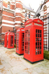 Fototapeta na wymiar Row of public red telephone boxes in London